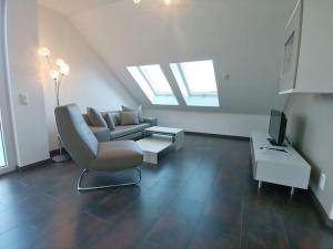 巴特贝林根Golf & Wellness Suite Bad Bellingen Apartment 5-9的客厅配有沙发和椅子