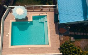 圣吕斯Villa Stone pour 8 personnes, piscine chauffée, accès PMR, 5 étoiles的游泳池顶部景,带遮阳伞