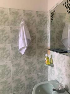 里考尔特Amazing Home Ricaurte-Casa verano piscina-Aire acondicionado的浴室配有水槽和墙上的毛巾