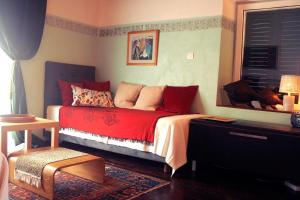 维斯Beautiful Vintage House的一间卧室设有红色的床和窗户。