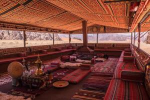 瓦迪拉姆Wadi Rum Fire Camp的一间大房间,位于一座建筑中,配有沙发和桌子