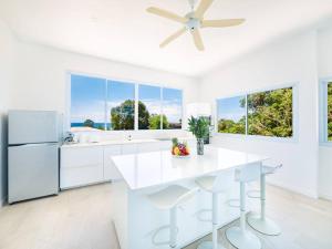 苏梅岛Villa Maviela Sea View 2 Bdr的白色的厨房配有吊扇和白色家电。