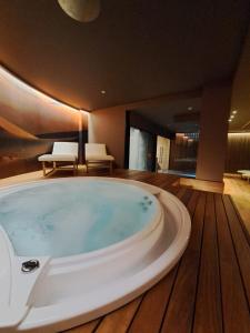 加利波利Biancodonda Lifestyle Hotel & SPA的铺有木地板的客房内设有一个大浴缸