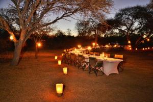 马布拉Safari Plains的一张长桌,晚上在田野里放蜡烛