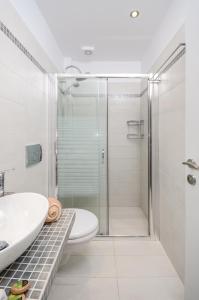 米科利维亚Victoria Studios & Apartments的带淋浴、卫生间和盥洗盆的浴室