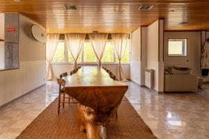 卡尔卡维洛斯Lisbon Surf Hostel的一张大木桌,位于房间中间