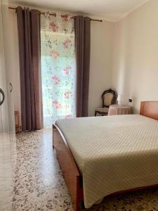 杰拉La casetta del mare的一间卧室设有一张大床和一个窗户。