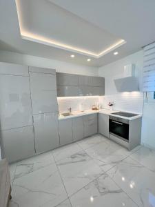 VergiaBeachfront Villa Athina的白色的厨房设有水槽和炉灶。
