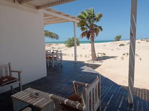RabilOcean House sol y mar #1的海滩上带桌椅的天井