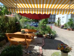 GermerodeFerienwohnung Mohnbrise的庭院设有野餐桌和遮阳伞。
