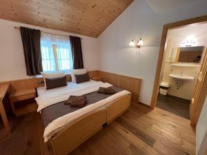 LongostagnoGasthaus Bad Siess的一间卧室设有一张大床和一个水槽