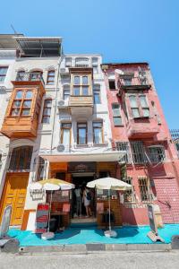 伊斯坦布尔Merdin Suites & Hotel - Downtown的前面有两把遮阳伞的高楼