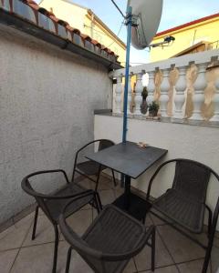 诺维·维诺多尔斯基Aretha apartman i sobe的阳台配有桌椅和遮阳伞