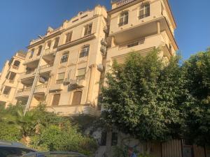 开罗Apartment with a private garden in New Cairo的前面有树木的白色大建筑