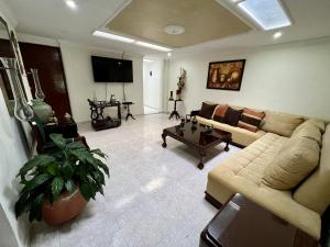 锡卡西亚Tucan Hostal的客厅配有沙发和桌子