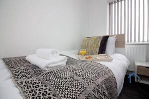 唐克斯特Wheatley Casa, 3 bed, driveway, workspace, wifi, corporates,pets的一张带毛巾的床和一盘食物