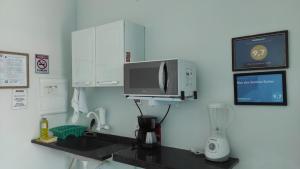 乌巴图巴Mar dos Sonhos Suítes的厨房配有咖啡机和微波炉