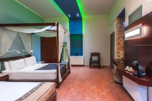 干尼亚斯普兰泽雅精品酒店的一间卧室设有天蓬床和绿色天花板