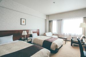 金泽金泽国际酒店的酒店客房设有两张床和窗户。