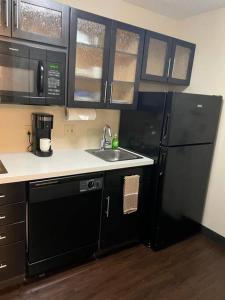 休斯顿Ultimate Escape/Free Parking的厨房配有黑色冰箱和水槽