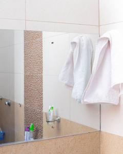 内罗毕Forget your worries in this serene 5 Bedroom Villa in Ngong的浴室设有挂在镜子上的白色毛巾