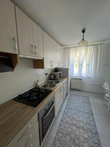 皮什Domek Mazury Pisz的厨房配有白色橱柜和炉灶烤箱。