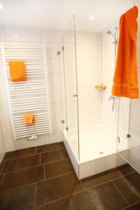 梅彭马克施密特酒店的浴室配有淋浴间和浴缸。