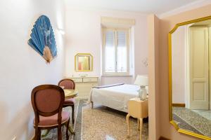 利沃诺Livorno Central Flat-2 min walk the Cathedral!的一间卧室配有一张床、一张桌子和一面镜子