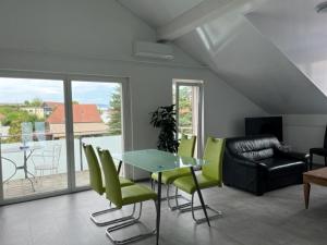 KerzersHotel Hippel Krone的客厅配有玻璃桌和绿色椅子