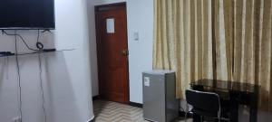 马尔多纳多港Makasai Tambopata 3的一间设有桌子、电视和门的房间