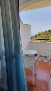 贝纳尔马德纳Benalmarina Sea View Apartments的阳台配有桌椅和窗户。