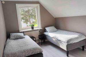 博登Spacious 6-bedroom villa!的一间卧室设有两张床和窗户。