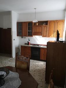 卡斯蒂戈隆·多尔希亚Casa Raffaello的厨房配有木制橱柜和炉灶烤箱。