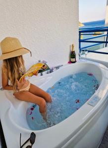 波罗斯克里斯蒂娜公寓式酒店的坐在浴缸里的女孩,喝一瓶葡萄酒