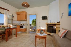 古瓦伊Fotis Studios Apartments的厨房以及带沙发和桌子的客厅。
