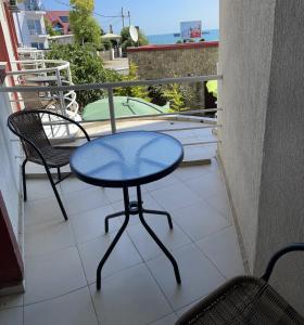 科斯蒂内什蒂Vila Julia Costinesti的阳台配有一张桌子和两把椅子