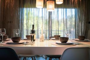 帕雷恩特西菲基昂Olea Residence Palio的一张带一瓶葡萄酒和眼镜的白色桌子