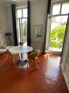 马赛Maison Dormoy的客厅配有桌椅和窗户。