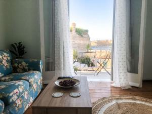 Ágios RókkosCorfu Fortress Apartment的带沙发、桌子和窗户的客厅