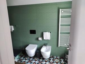 萨卢佐Hotel & Apartments " Perpoin "的绿色浴室设有卫生间和水槽