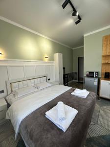 卡拉科尔Vavilon的一间卧室配有一张大床和毛巾