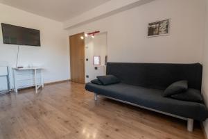 科姆梅扎杜拉Ride Home - Val di Sole的客厅配有沙发和桌子