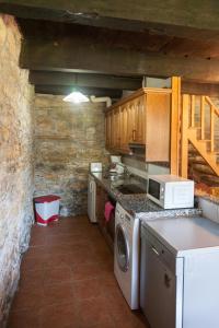 贝加德瓦尔卡尔塞Casa Rural Pandelo的厨房配有炉灶和洗衣机。