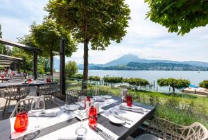 卢塞恩HERMITAGE Lake Lucerne - Beach Club & Lifestyle Hotel的湖景餐厅餐桌