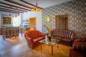 GaalLorettohof Hotel Garni的客厅配有两张真皮沙发和一张桌子