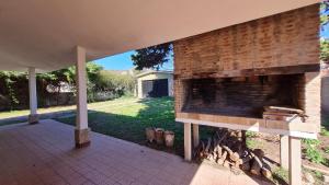 维拉卡洛斯帕兹Casa Rustica的庭院内带砖墙的户外壁炉