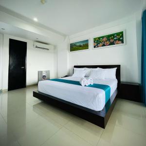 塔拉波托RBB BRITO HOTEL的一间卧室配有一张带白色床单的大床