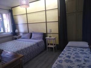 蒙法尔科内appartamento centro storico的一间卧室配有两张床和一张桌子