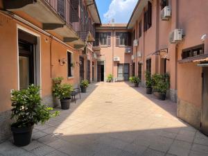 米兰Corte del 6 - Cozy Modern Flat的一座建筑里满是盆栽植物的空洞小巷