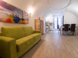 拉奎拉141 VIA ROMA的客厅配有绿色沙发和桌子